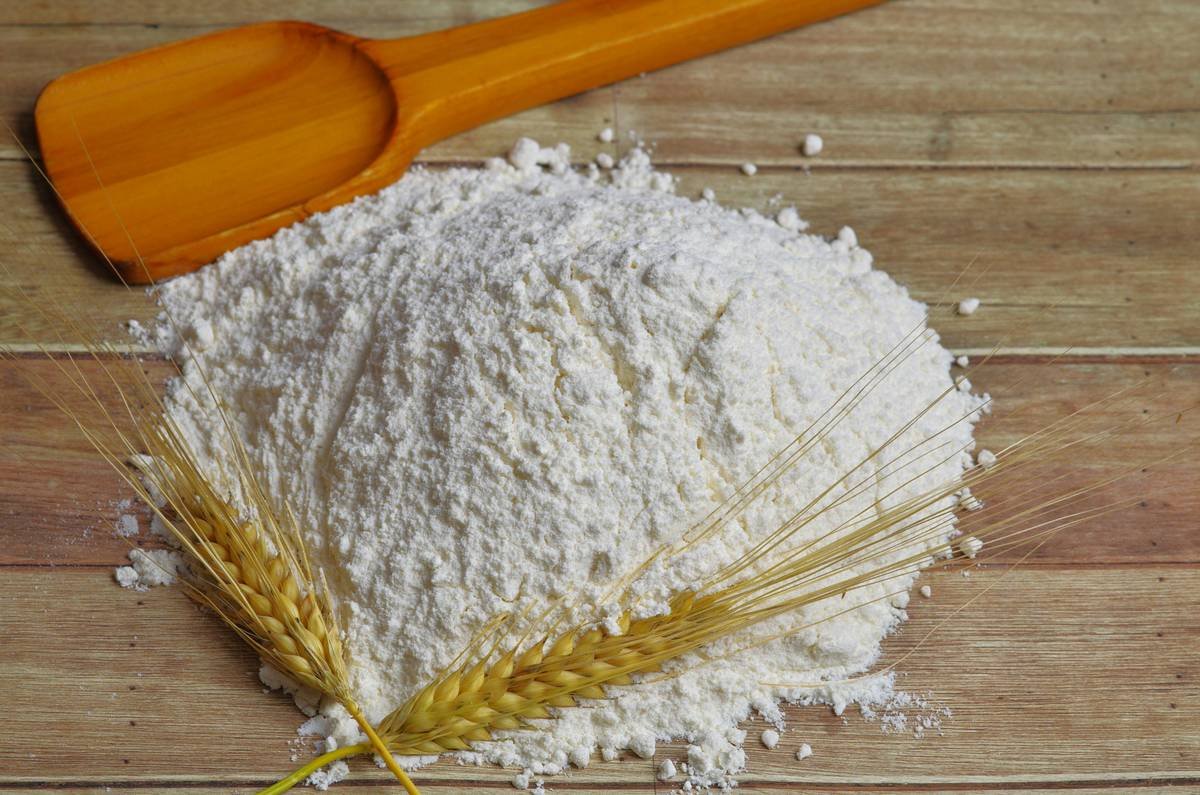 Side-by-side photo: left shows clumpy, discolored bread flour in open bin; right shows fresh, free-flowing flour in airtight opaque bin with tight gasket seal