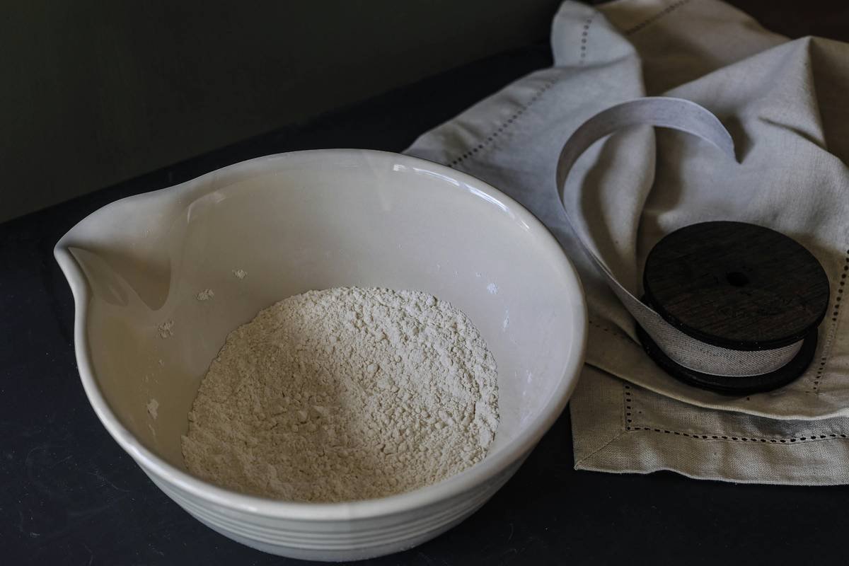 Side-by-side comparison: clumpy, discolored bread flour stored in paper bag vs. fresh, powdery flour in airtight container